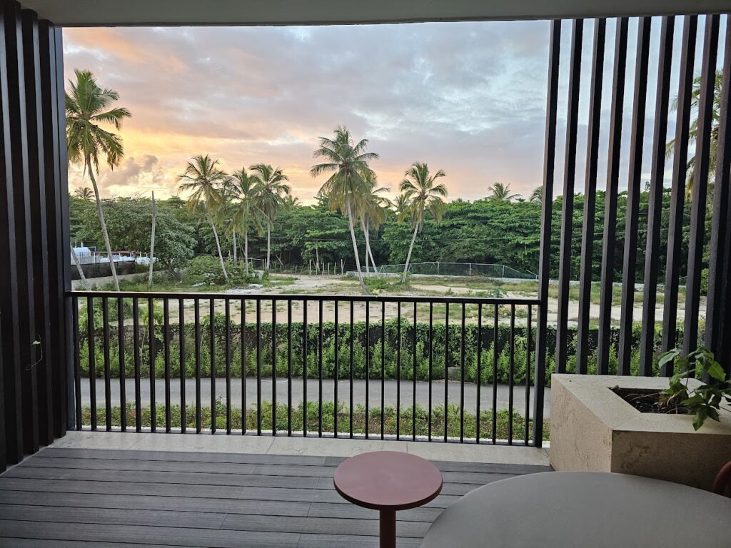Balcony view labeled tropical view at W Punta Cana overlooking resort grounds and nearby construction